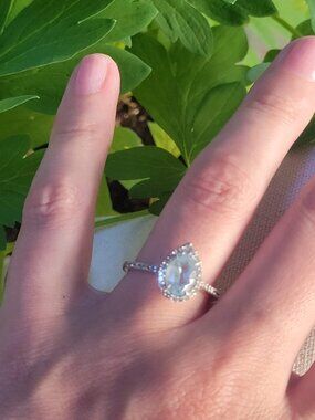 Oval Aquamarine and 0.29 Carat TW Diamond Halo Ring in 10kt WG